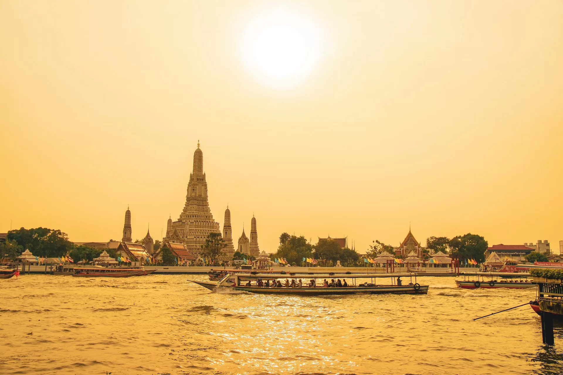 Pic of chao praya river with temple in background.